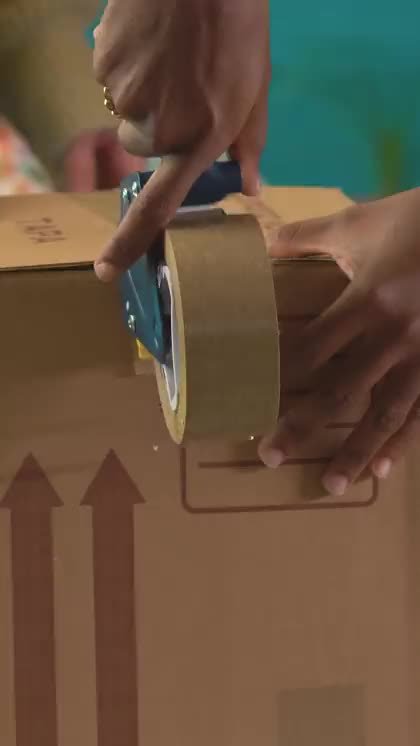 A shipper sealing and labeling a package before pickup